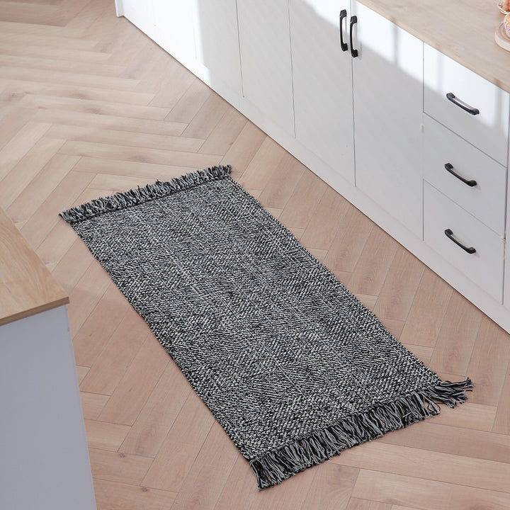 Handwoven table runner in herringbone pattern with decorative fringes