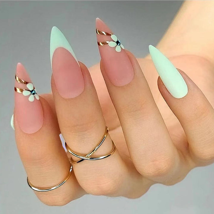 Artistic stiletto nails with floral accents and glitter embellishments Stornfield