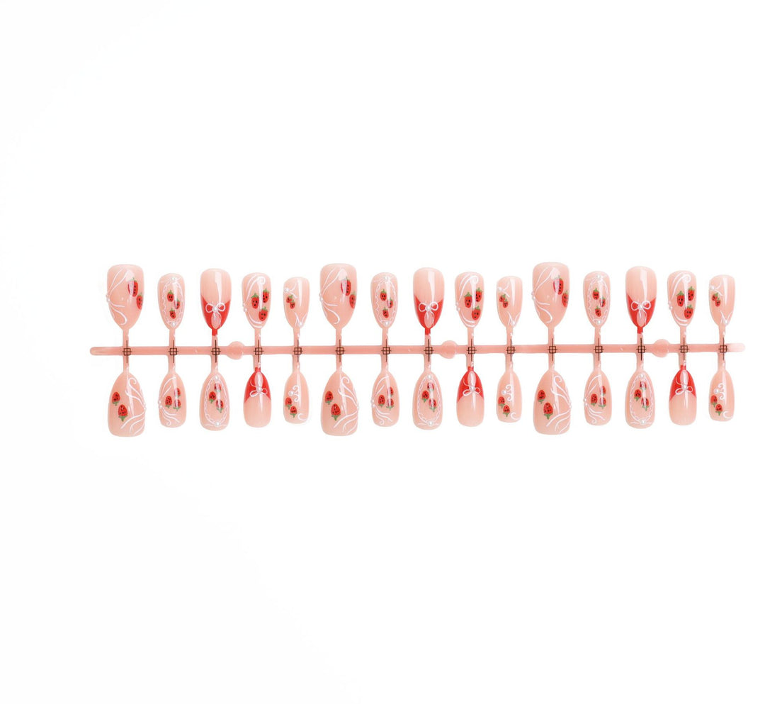 Artificial nail set with romantic strawberry and bow motifs Stornfield