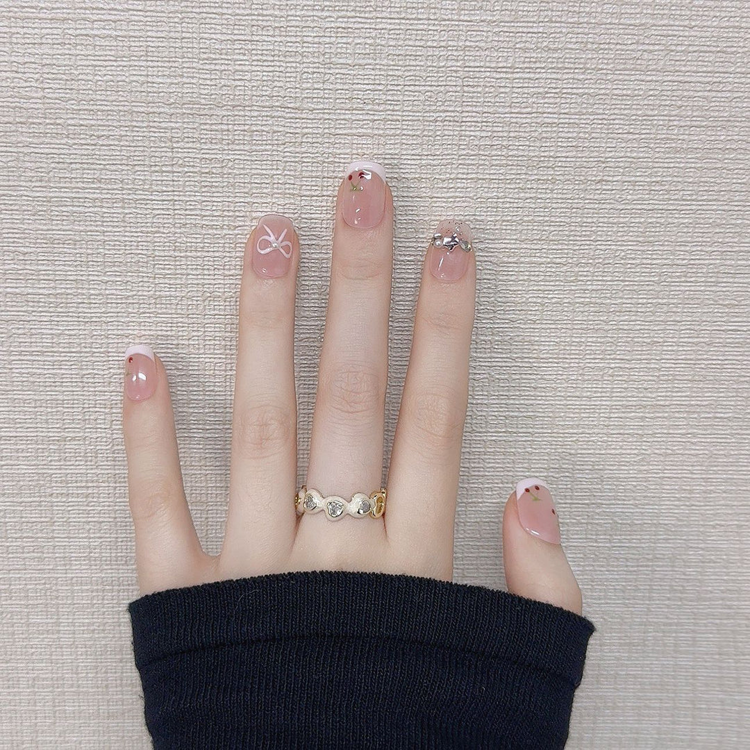 Decorative Press-On Nail Art with Floral and Bow Accents