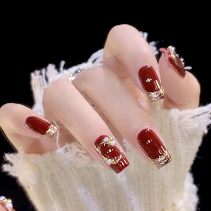 Artistic Nail Art with Glitter and Flower Applications Stornfield