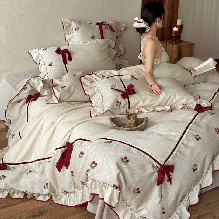 Country house bedding set made of linen-cotton blend with hand-embroidered cherry motifs, ruffles and decorative bows