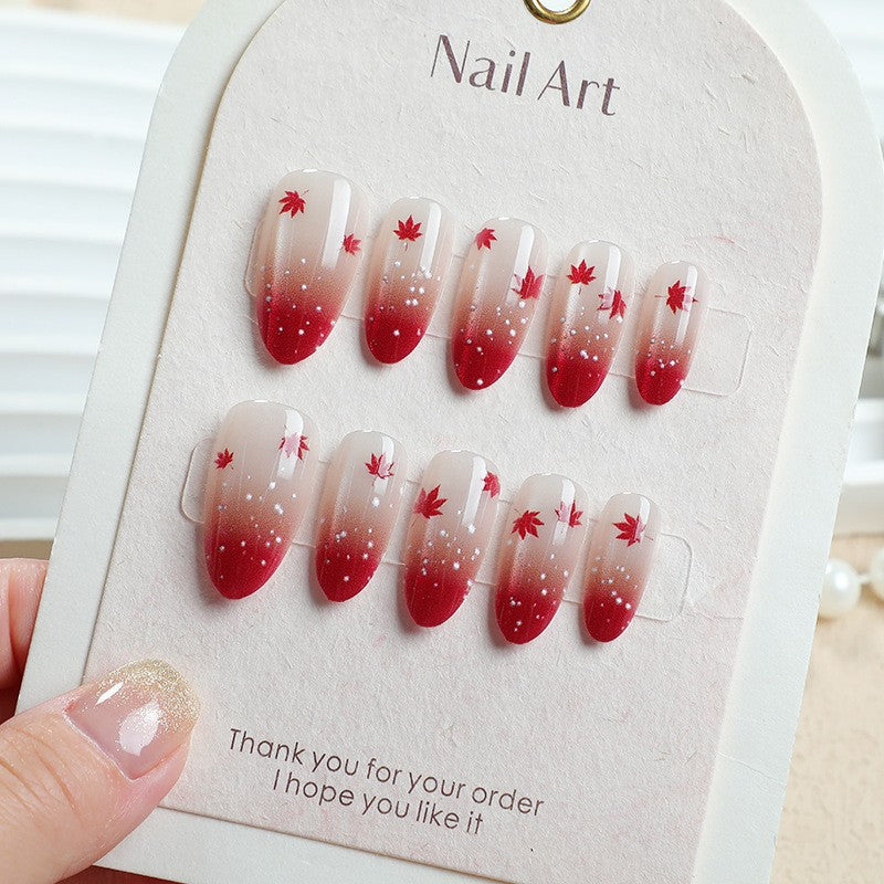Art nail set with elegant red ombré look and delicate maple leaves Stornfield