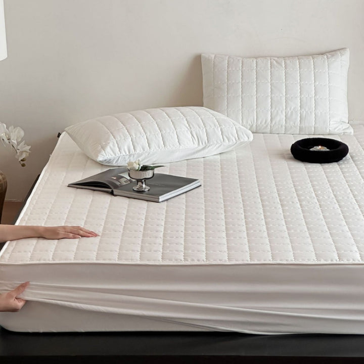 Padded quilted mattress topper with non-slip bottom and breathable fiber filling