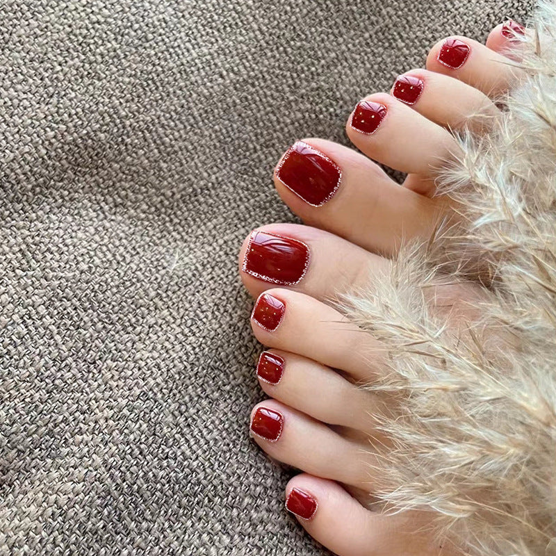 Artistic toenail art with rhinestone and glitter elements Stornfield