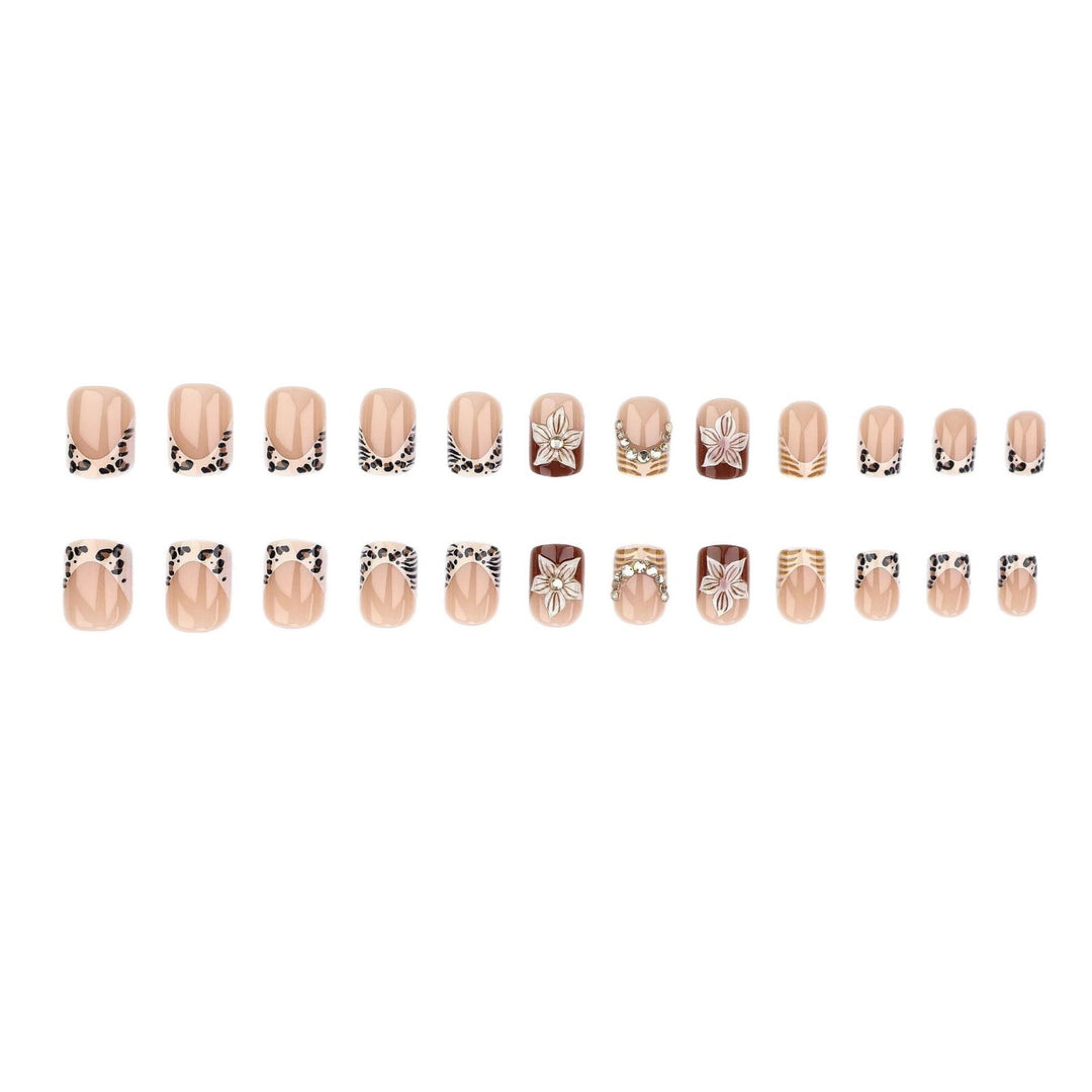 Artificial nail set with floral embellishments and elegant glitter details Stornfield