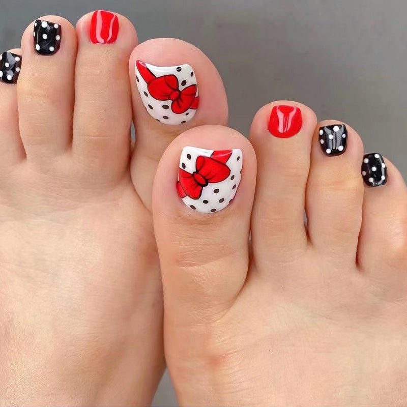 Artful toenail design with elegant bow motifs Stornfield