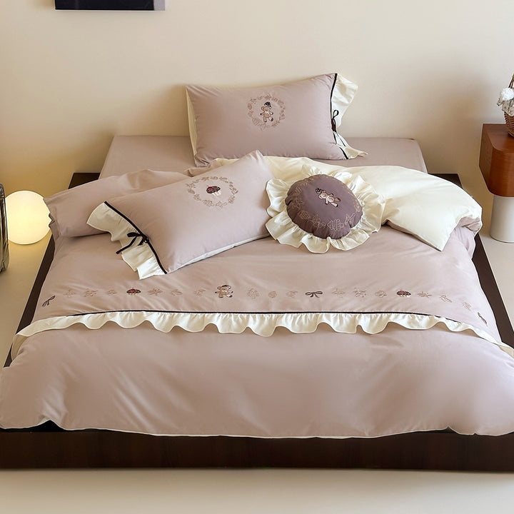 Embroidered bedding set with ruffled trim, teddy design and decorative pillow