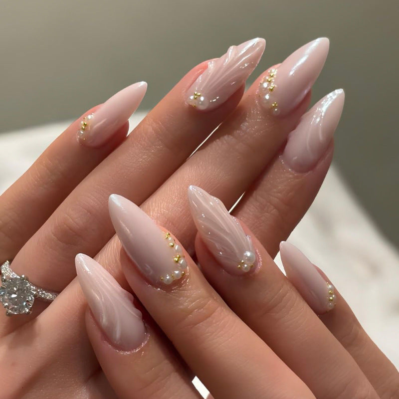 Elegant stiletto nails with shimmer design and pearl decorations Stornfield
