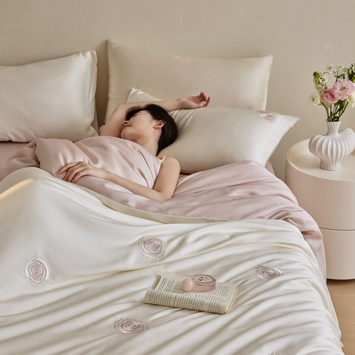 Luxurious satin bedding set with floral embroidered rose details and reversible function