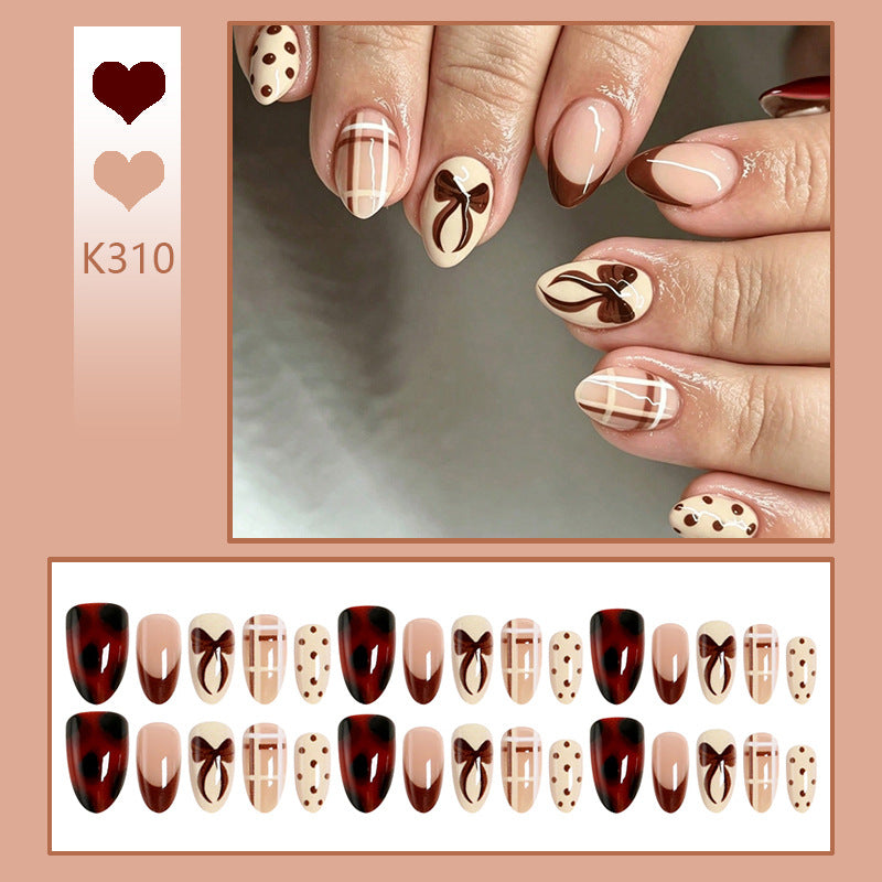 Artificial nail set with elegant bow and caramel designs Stornfield