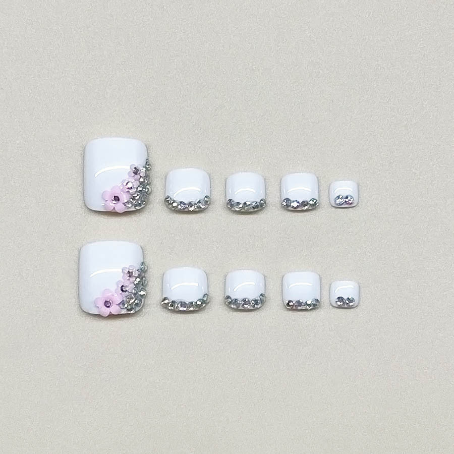 Nail art set with elegant glitter embellishments and floral accents Stornfield