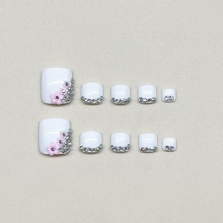 Nail art set with elegant glitter embellishments and floral accents Stornfield