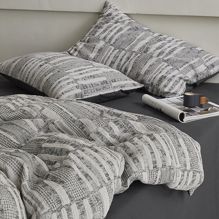 Quilted bed set with textured jacquard stripe design