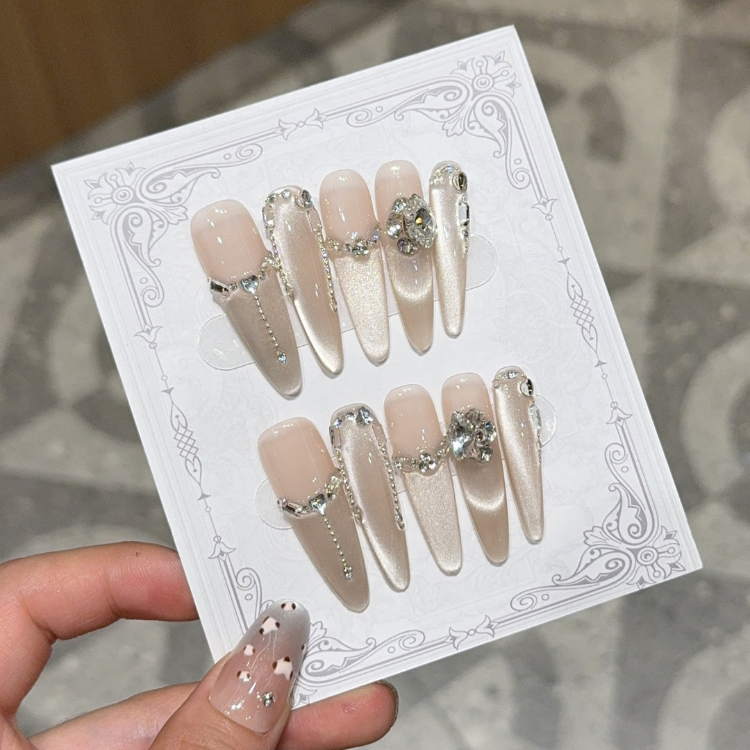 Glamorous nail tips with rhinestone and glitter effects Stornfield