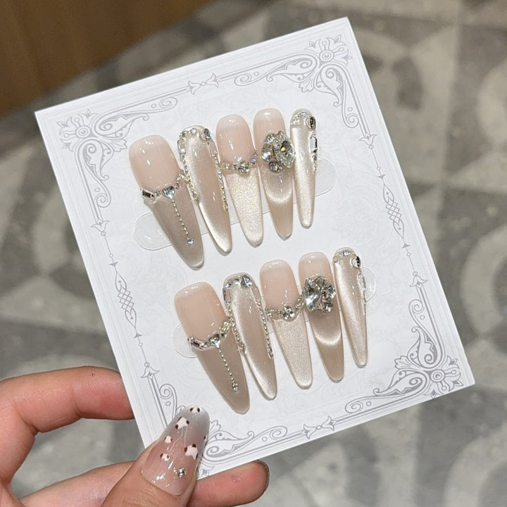 Glamorous nail tips with rhinestone and glitter effects Stornfield