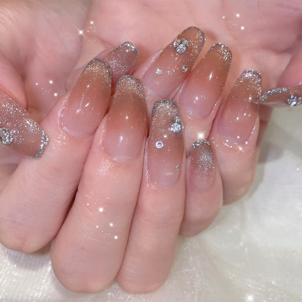 Glamorous artificial nails with glitter and rhinestone accents Stornfield