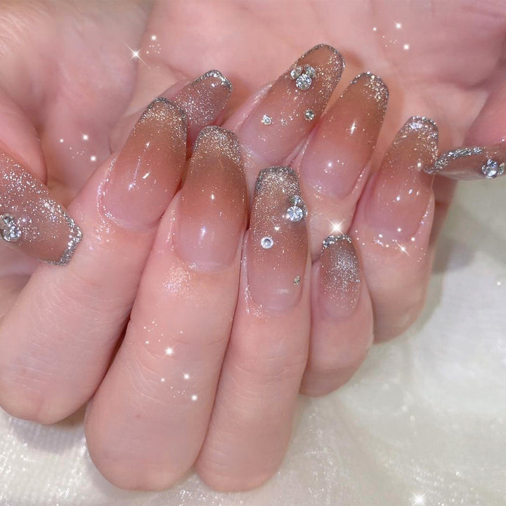 Glamorous artificial nails with glitter and rhinestone accents Stornfield