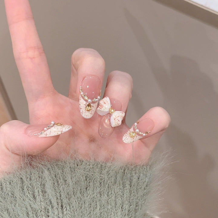 Artificial nails with elegant accents and rhinestone embellishments Stornfield