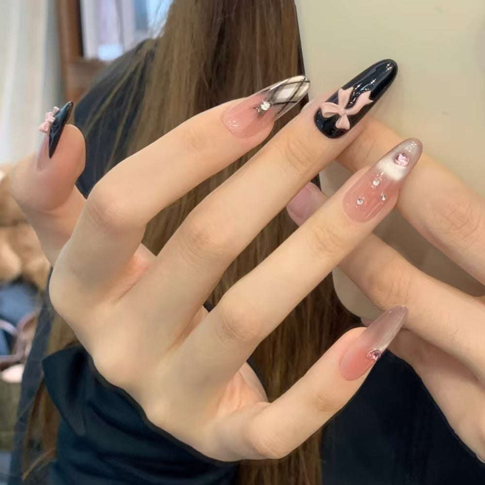 Artificial nails with playful bow and glitter accents Stornfield