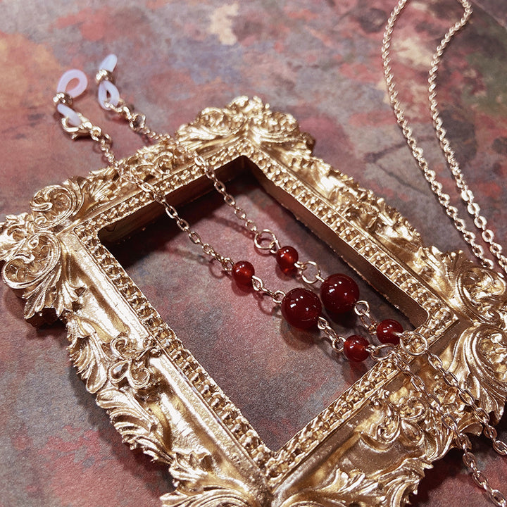 Elegant jewelry holder chain with red accents Stornfield