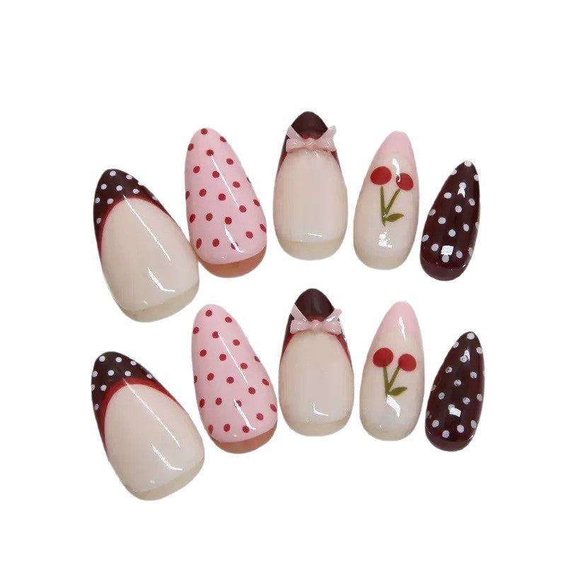 Artfully designed nail tips with cherry and dot motifs Stornfield