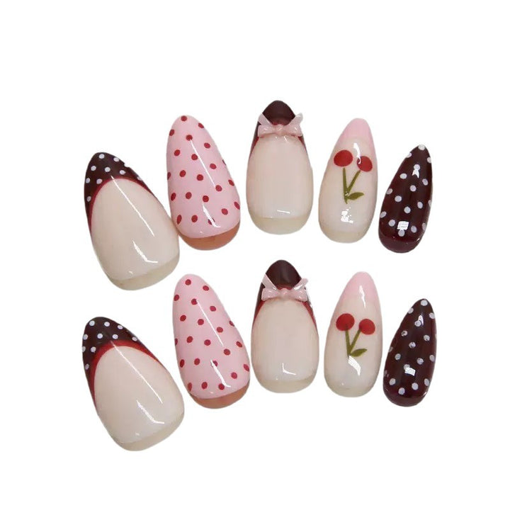 Artfully designed nail tips with cherry and dot motifs Stornfield