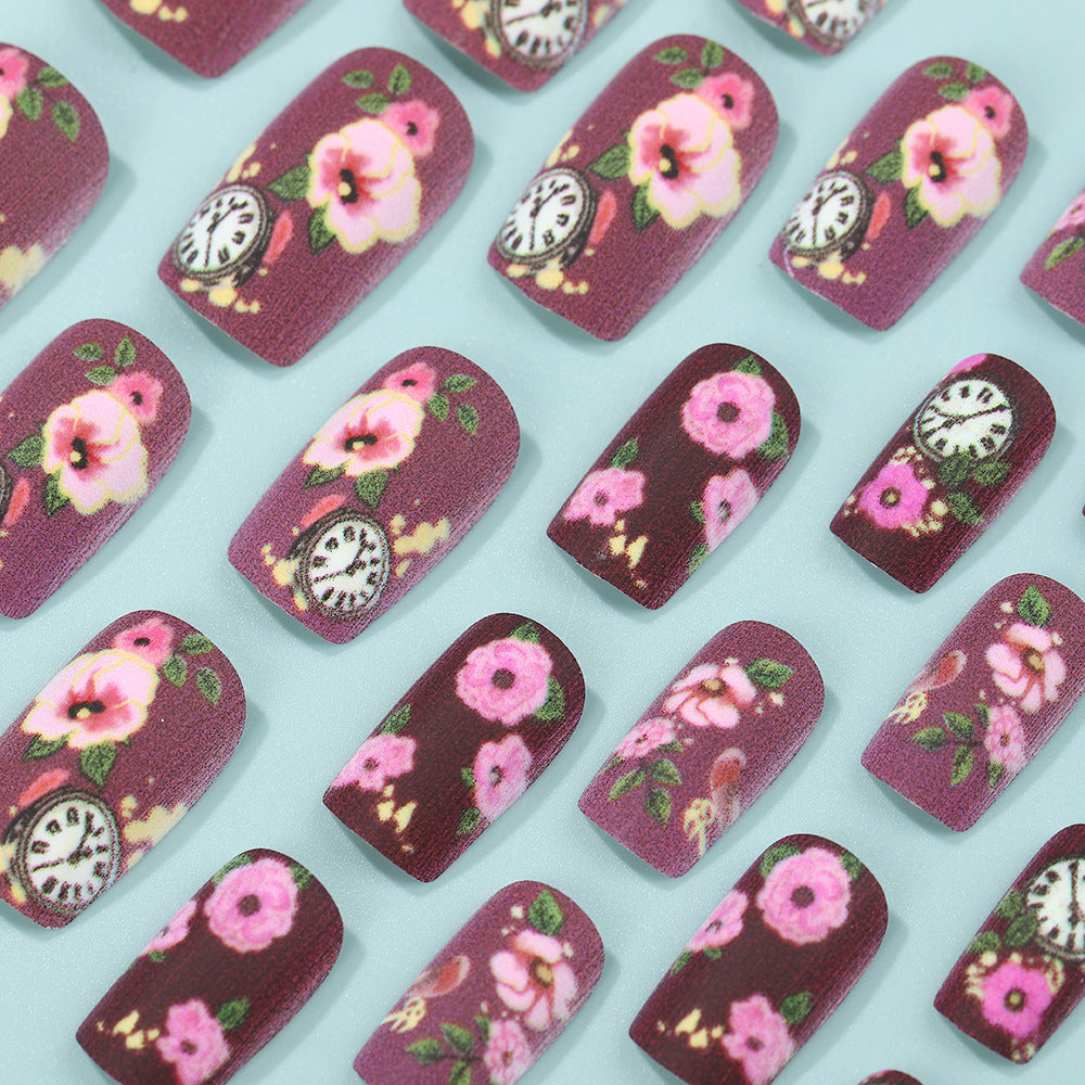 Nail art with floral design and intricate clock motifs Stornfield