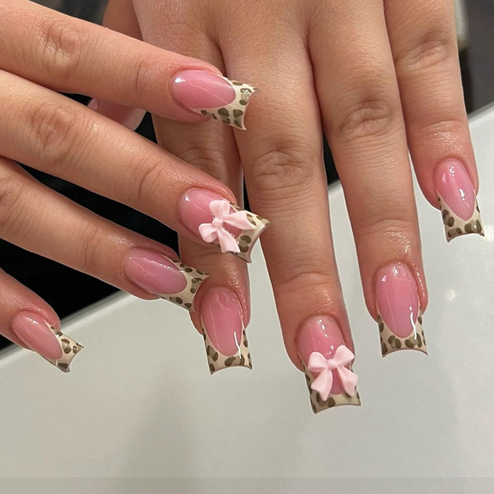 Nail set with elegant leopard accents and bow embellishments Stornfield