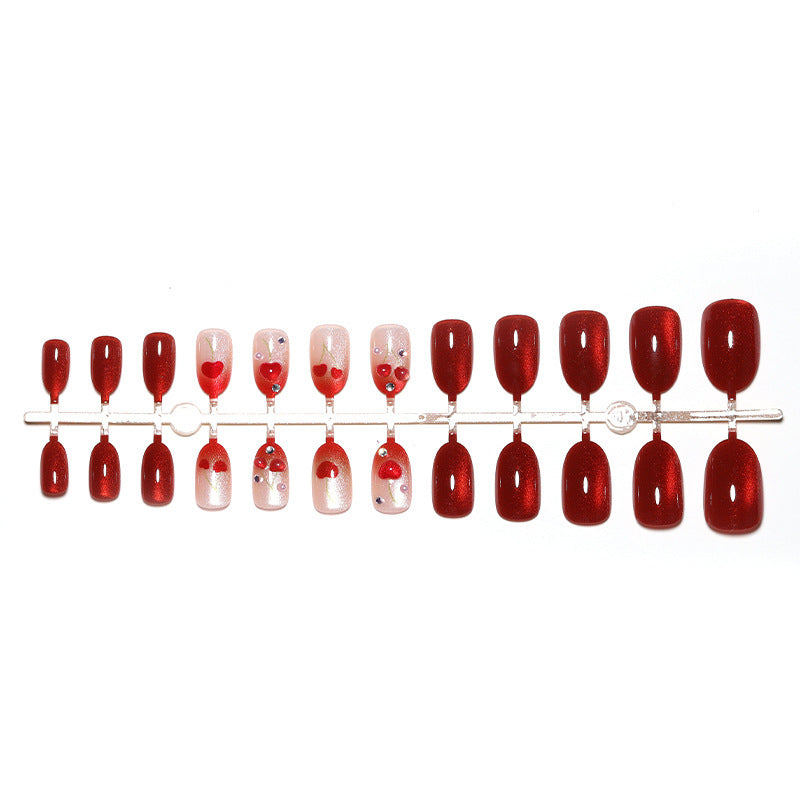 Artificial nail set with glamorous accents and creative heart motifs Stornfield