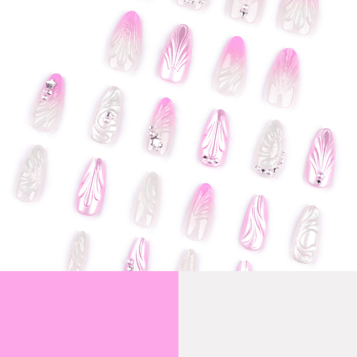Artificial nail art with elegant swirl design and pearl embellishments Stornfield