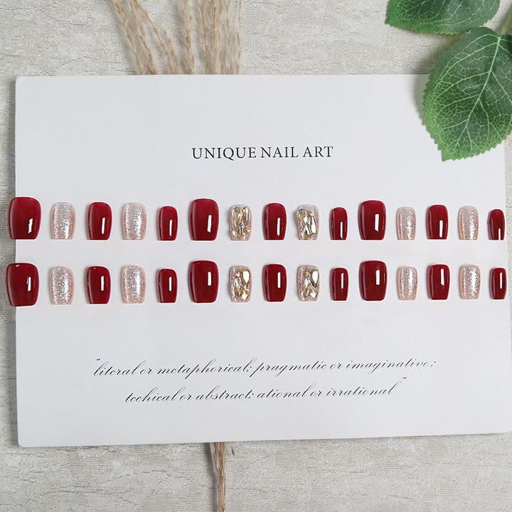 Artificial nail set with elegant glitter and metallic accents Stornfield