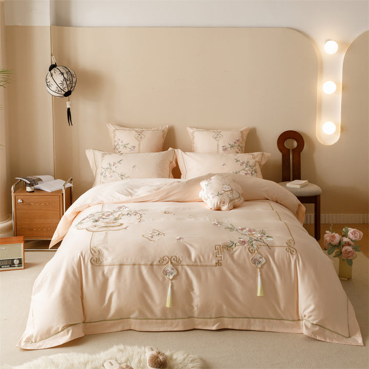 Luxurious cotton satin bedding set with fine embroidery, floral motifs, and decorative pillows