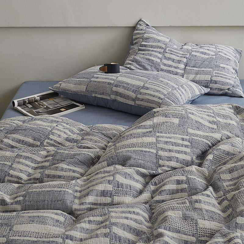 Quilted bed set with textured jacquard stripe design