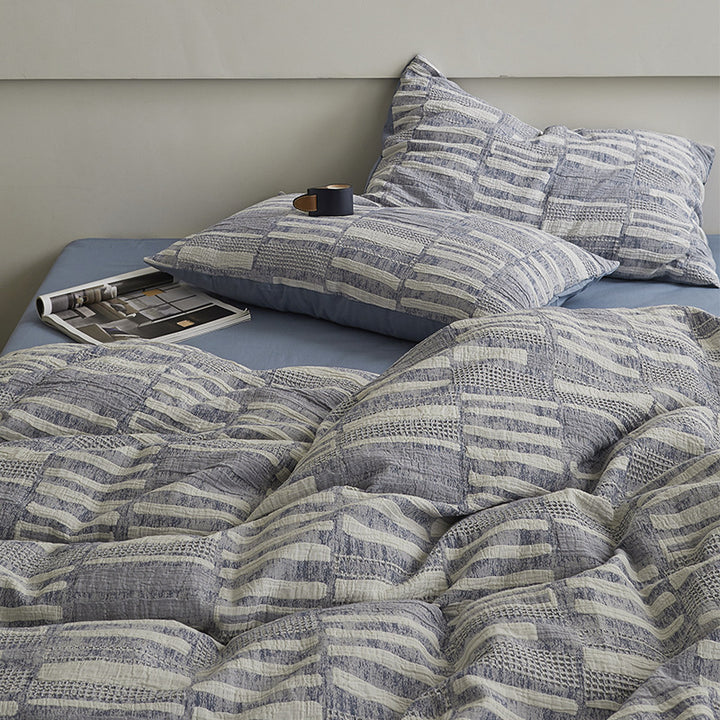 Quilted bed set with textured jacquard stripe design