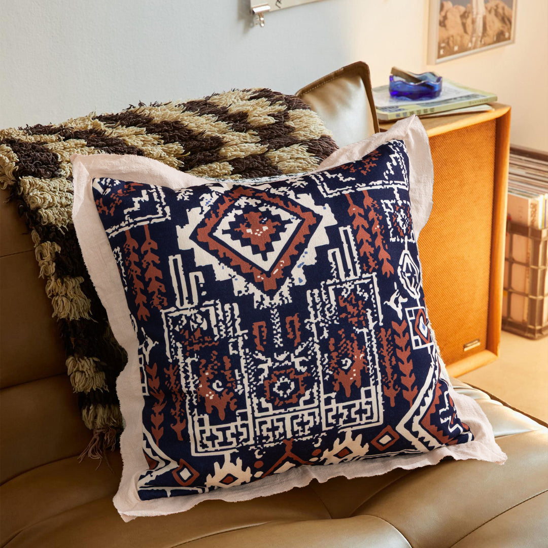 Square decorative cushion with mandala-like jacquard pattern and linen flange