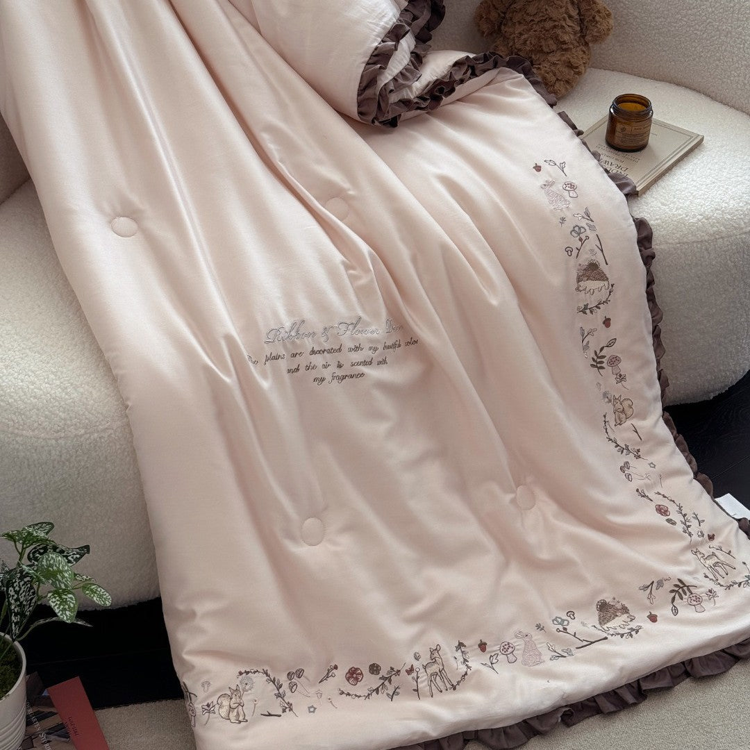 Quilted reversible duvet cover with floral embroidery and ruffled hem