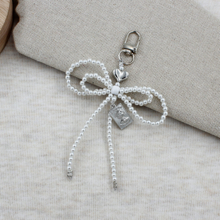 Elegant Beaded Bow Brooch Stornfield