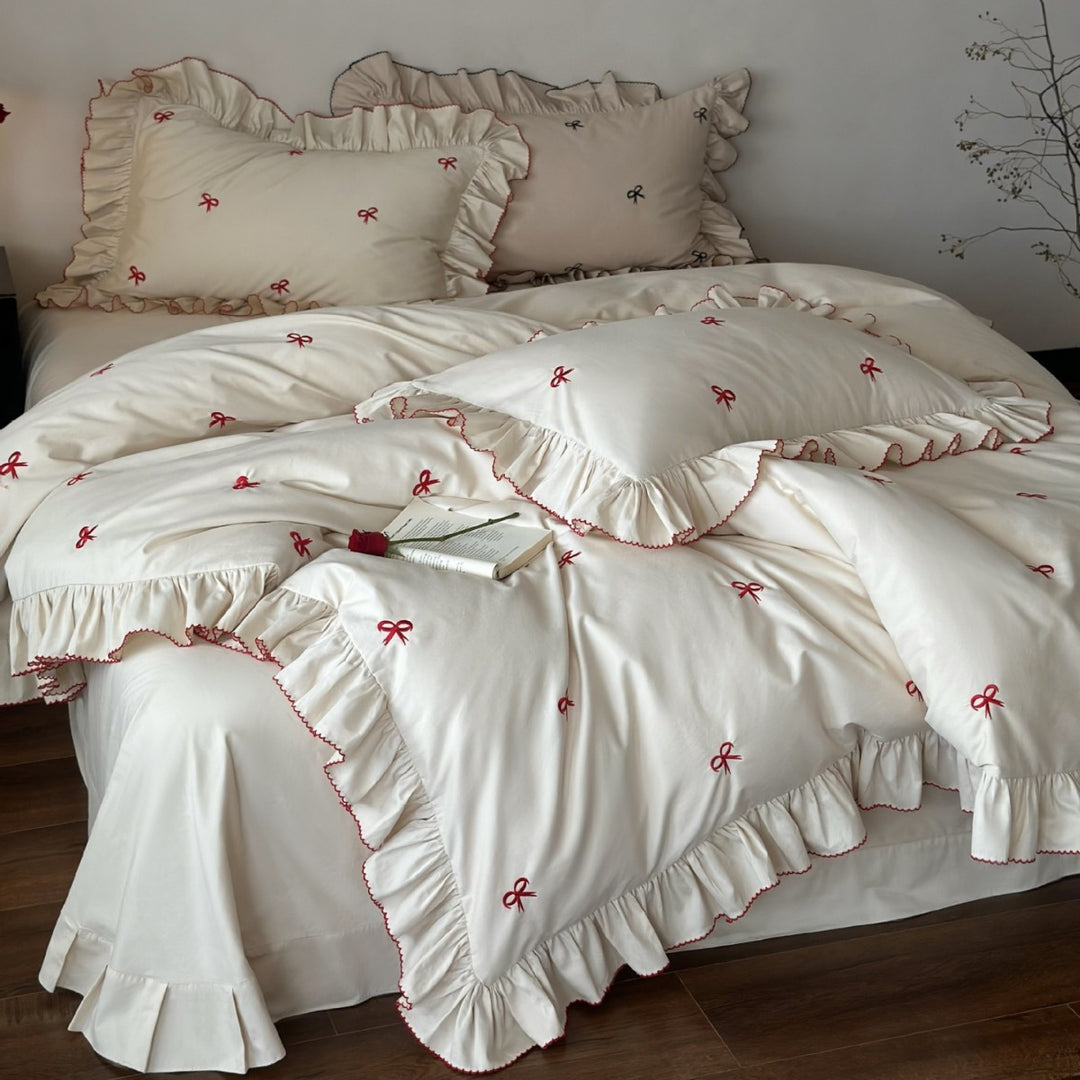 Ruffled bedding set with embroidered bows and frills