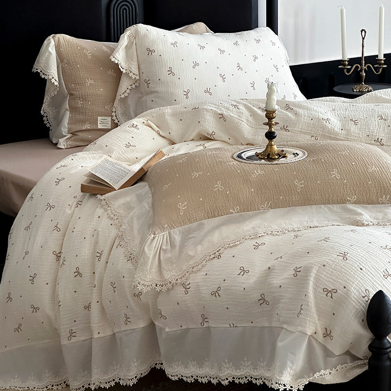 Cotton muslin bedding set with ruffles, lace trim, and delicate bow print