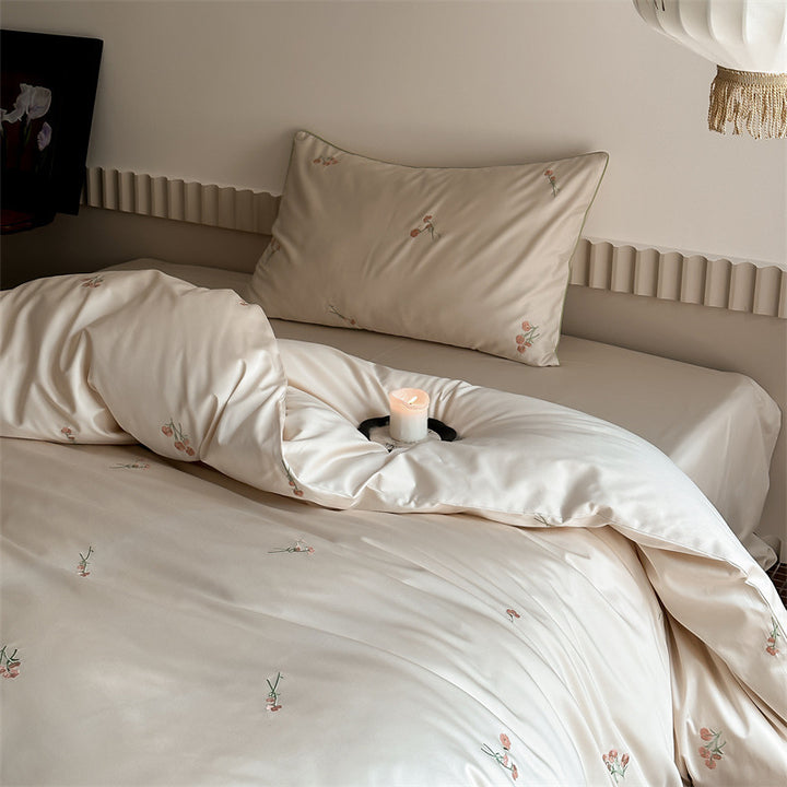 Luxurious cotton satin bedding set with delicate floral embroidery and a silky-matte surface