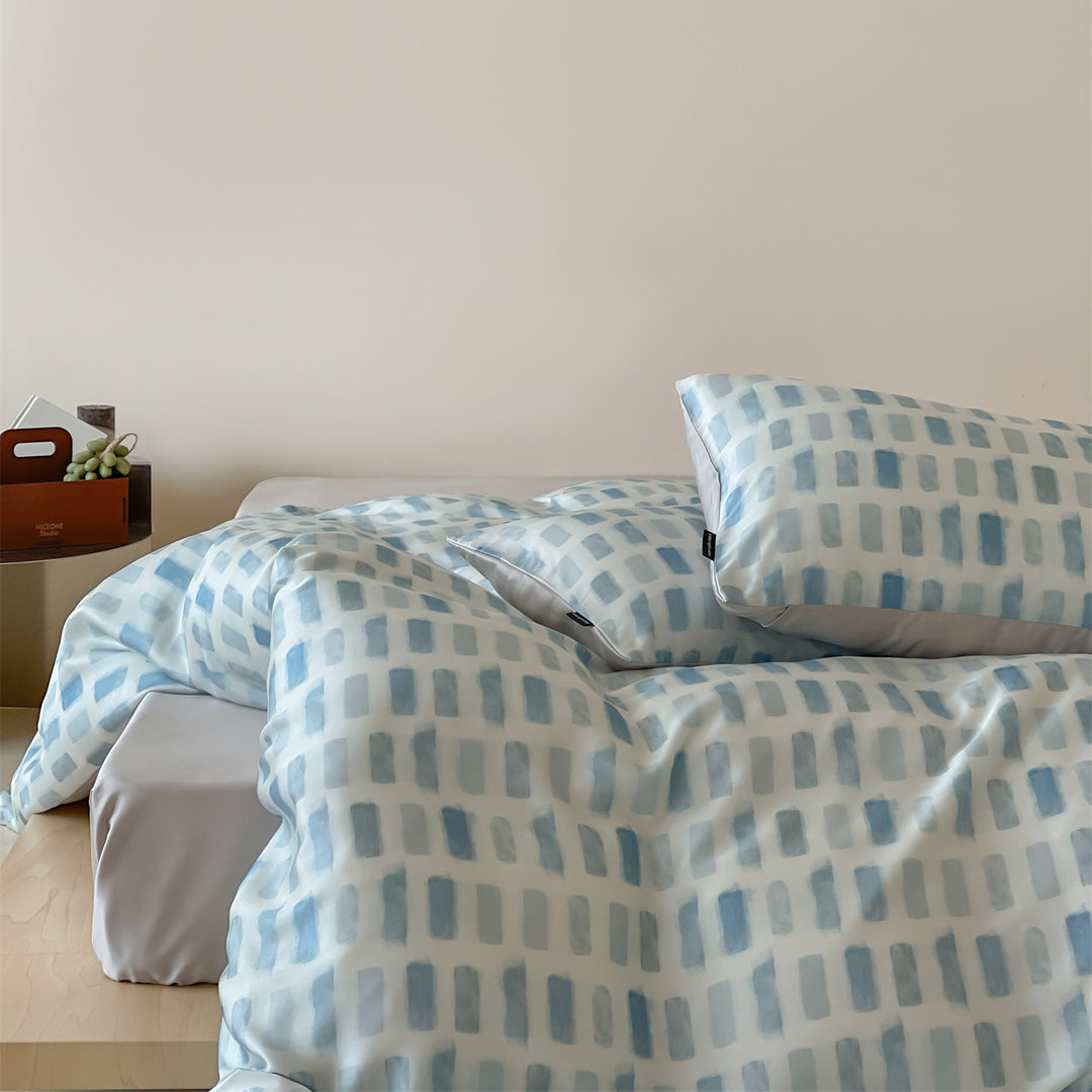 Luxurious satin bedding set with floral watercolor print, ruffled edges and reversible function