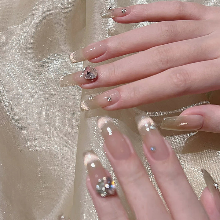 Acrylic nail set with glamorous glitter accents and elegant jewelry embellishments Stornfield