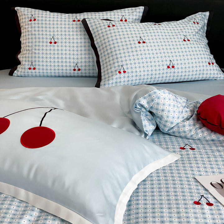 Playful cotton satin bedding set with cherry print and fine check pattern