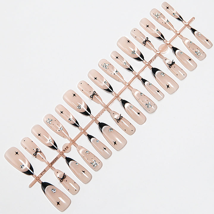 Nail art set with elegant black and white design and sparkling applications Stornfield