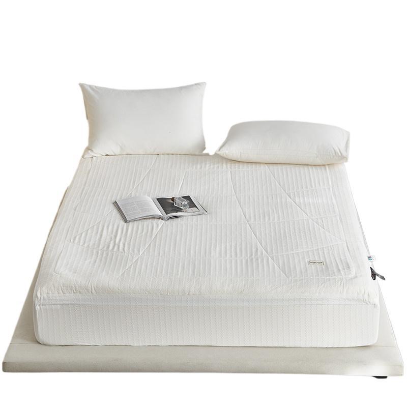Padded mattress topper with quilted microfiber surface and non-slip fitted edge