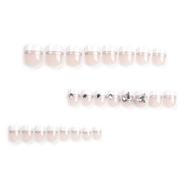 Elegant Nail Art with Glitter Accents and Jewelry Details Stornfield