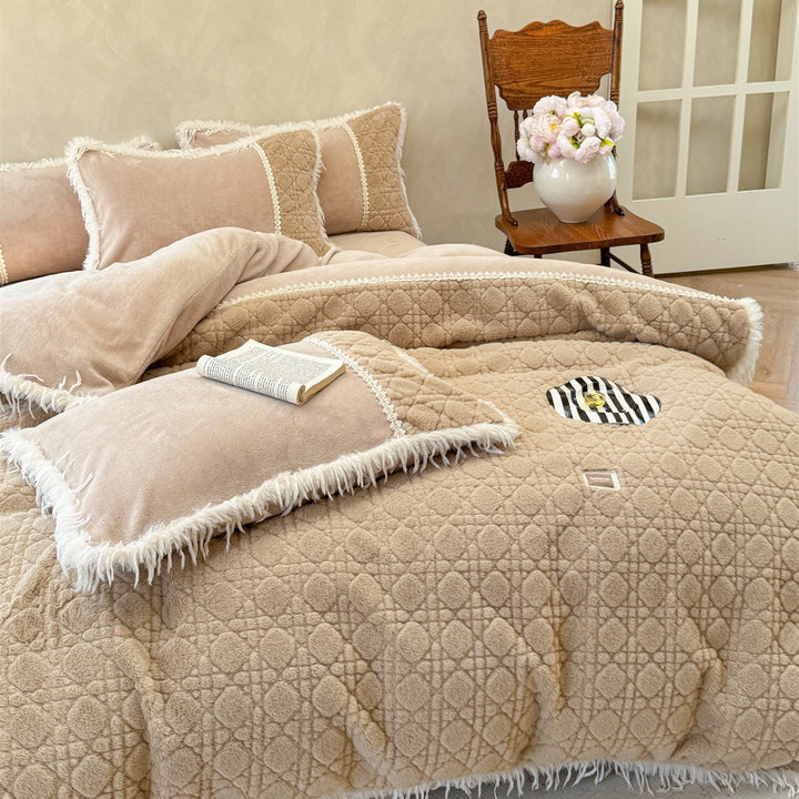 Quilted bedding with fringes and decorative pillows