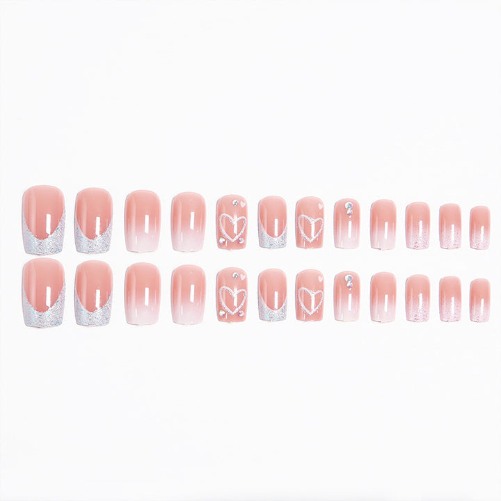 Artificial nails with sparkling heart designs and glitter details Stornfield