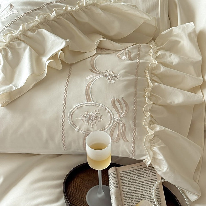 Luxurious satin bedding set with ornamental embroidery and gathered hem